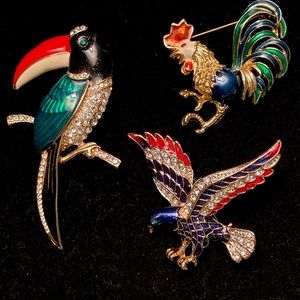 Trio of enameled and crystal animal pins